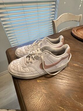 Nike White Low-Top Sneakers with Pink Swoosh Trim